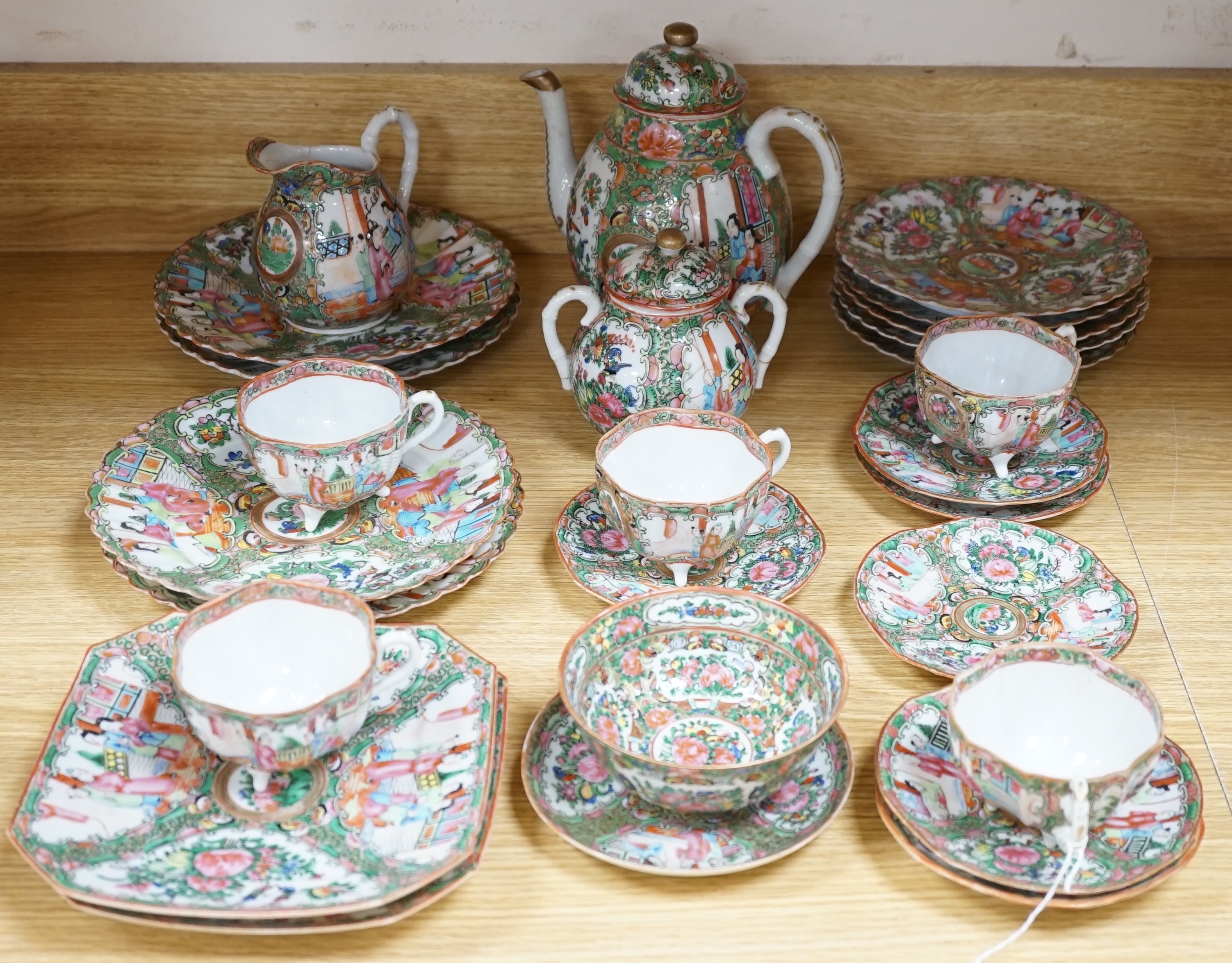 A Chinese famille rose part tea set including: five cups saucers and side plates, a teapot and cover, sugar bowl and cover, a cream jug, four cake plates and two square plates (27)